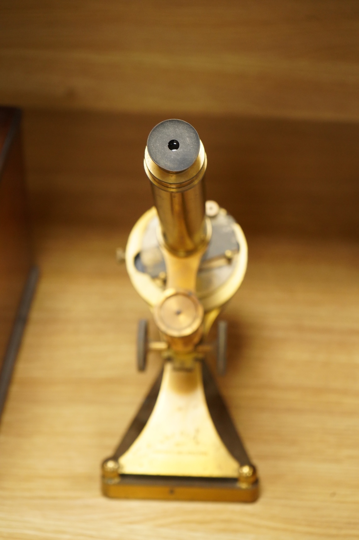 A late 19th century brass compound monocular microscope, by R and J. Beck, mahogany cased, with two objectives, 2 eyepieces and miscellaneous slides, the case dimensions; 40.5 x 15.5x 18cm, together with a small early 19